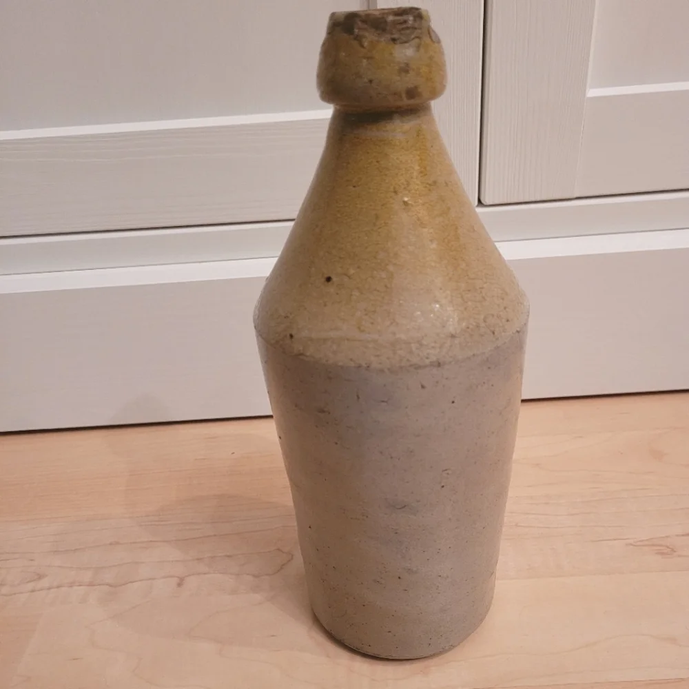 Antique John Howell cream beige pottery stoneware whiskey jug